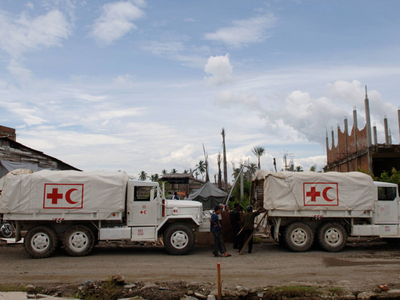 Two trucks marked with The Red Cross